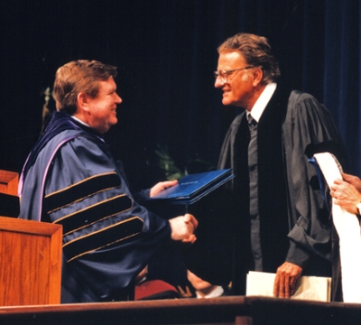 Dr. Billy Graham receiving an honorary degree from Dr. Marvin Watson