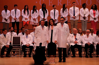 picture of Chloe in her white coat standing on stage