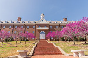 Spence Hall during the springtime in Dallas, Texas, with crape myrtle trees in full bloom