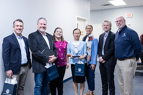 Dr. Chen standing with a group of faculty members