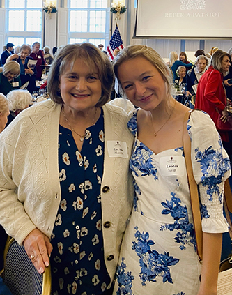 Mrs. Lee Ann Shamblin and London Smith standing in the Great Hall at DBU