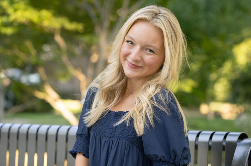headshot of London Smith outside with greenery background
