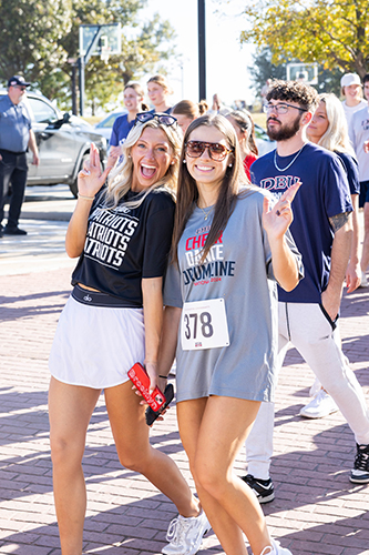 Homecoming Turkey Trot - two students posing for a picture