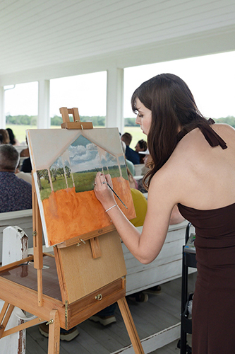 Ashley Huff painting a painting live at a wedding for commission