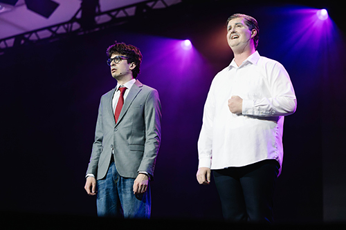 Two male college students on a stage performing at Spring Sing at a Christian college in Texas