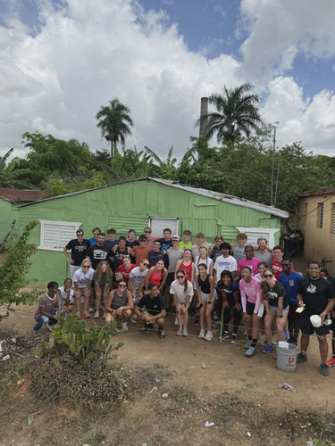 DBU athletes and Dominican children pose at mission site