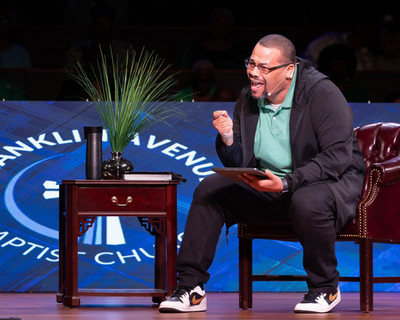 Pastor Chip Luter seated on stage addressing an audience