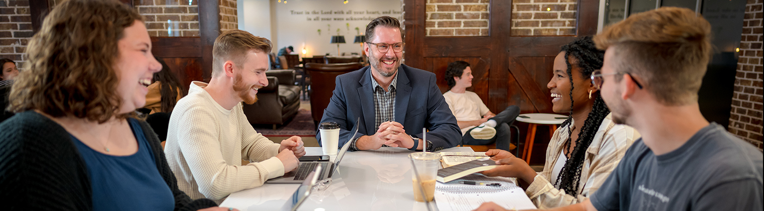 DBU Campus - college students meeting with a faculty member in the coffeeshop on campus