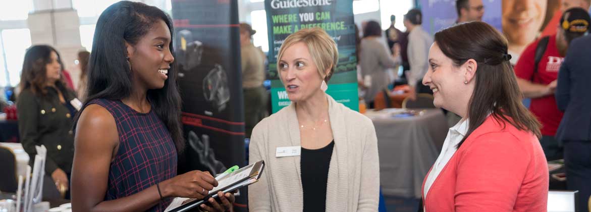 Three women talking at the career expo