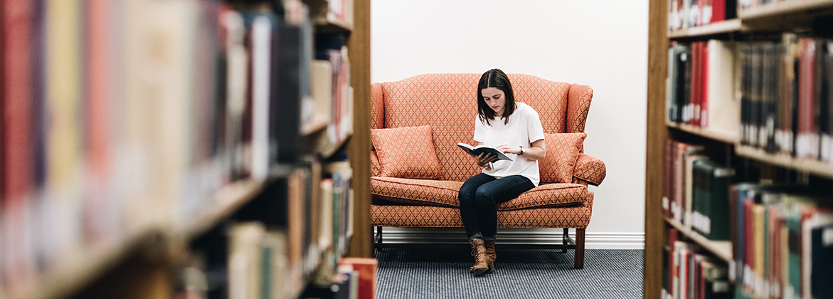 Girl Reading in Library