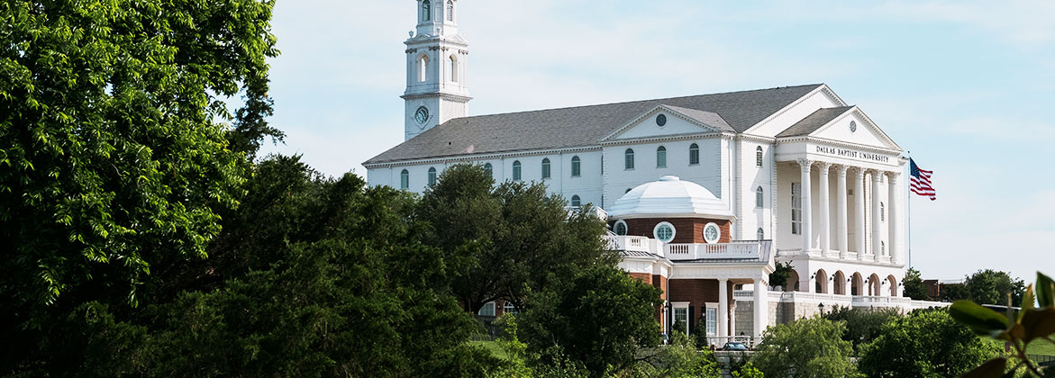 nation hall and chapel with trees and american flag flying