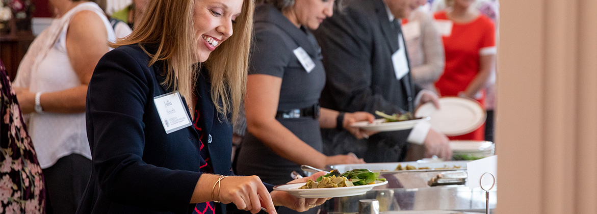 woman smiles in buffet line