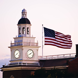 picture of the American Flag with a building behind it