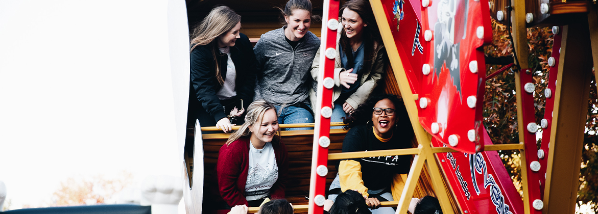 Student's riding a ride at tailgate party