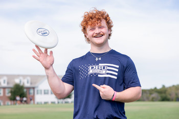 Student spinning a frisbee