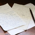 desk with pieces of paper piled up