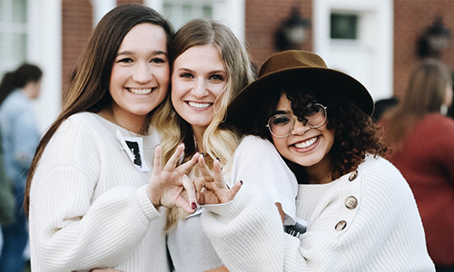 group of 3 college students at a student organization event