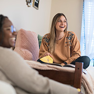 Two girls hanging out at a dorm room