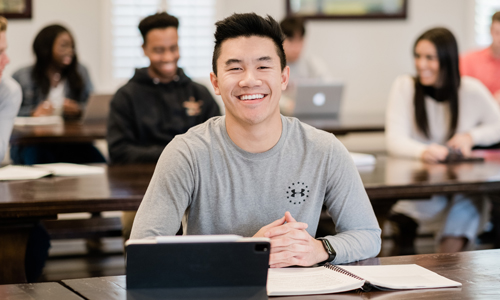 a boy laughs and smiles at the camera