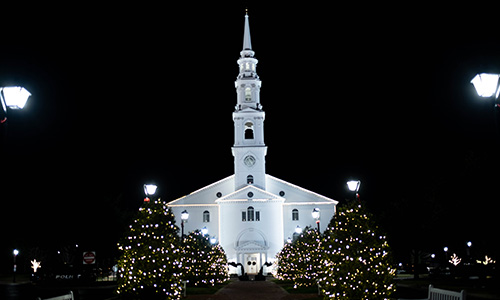 chapel lit with Christmas lights at night