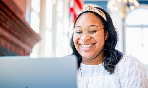 person smiling at computer