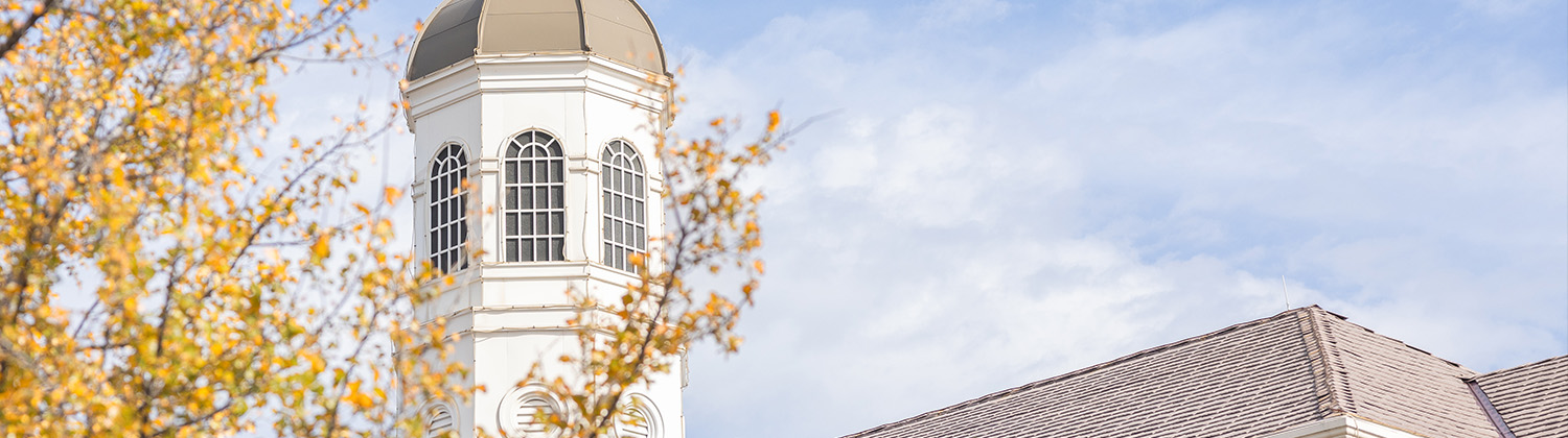 DBU campus building with fall tree