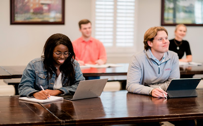 two dallas college students studying and laughing