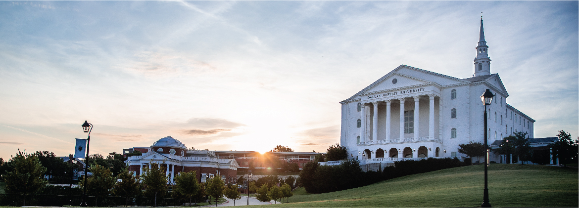 A new day dawns on the DBU campus - sunrise in the background behind buildings in Dallas, Texas