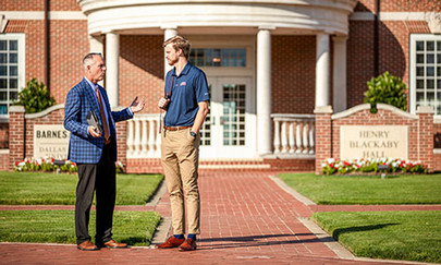 DBU Bookstore bell tower - faculty and student talking outside