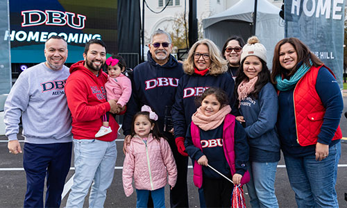 picture of a family in front of the DBU Homecoming stage