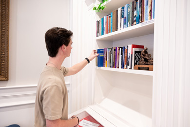 student checking out a book in the Center for Baptist History