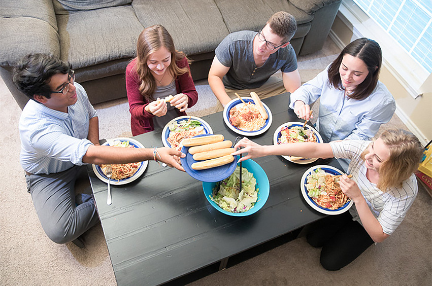 college students enjoying a home-cooked meal