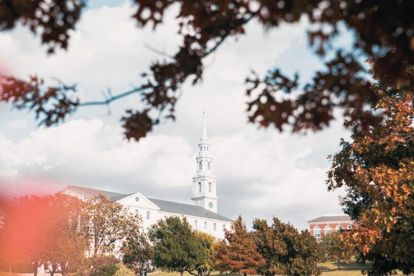 The DBU Chapel appears through fall leaves
