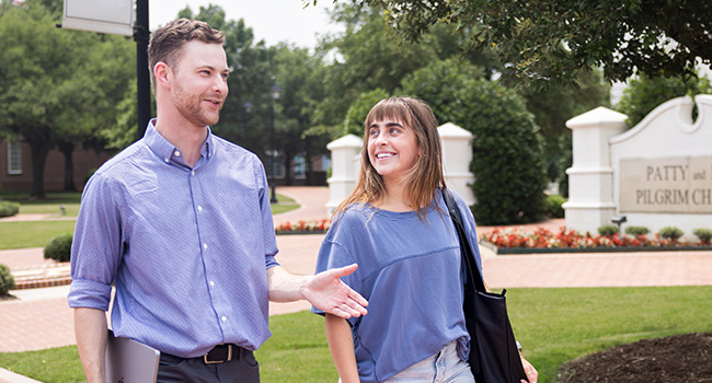 DBU students walking and talking on campus