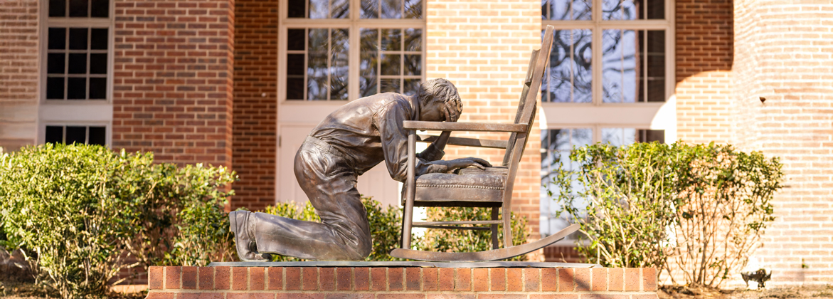 Called to pray statue on the campus of dallas baptist university