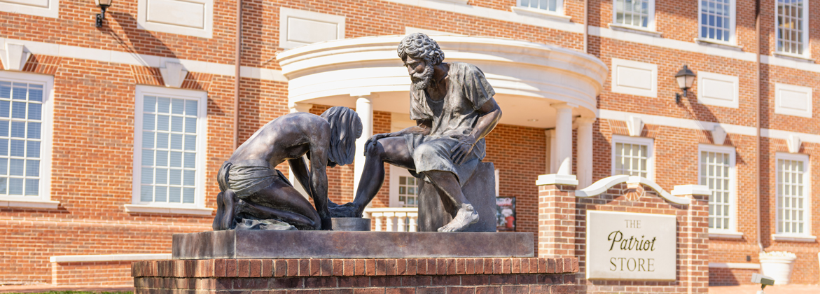 Servant leadership statue showing Jesus washing Peter's feet