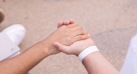 hands of two people clasped in prayer