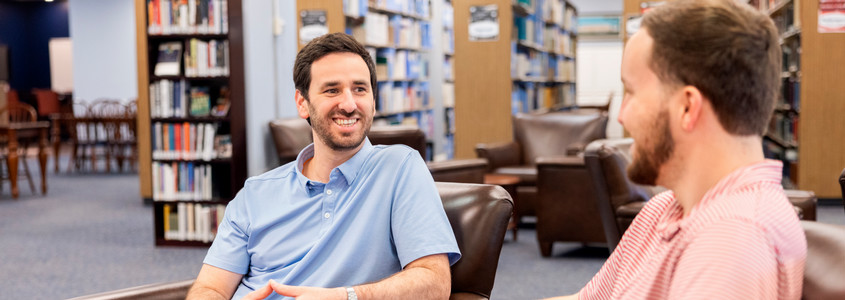 DBU student smiling in library