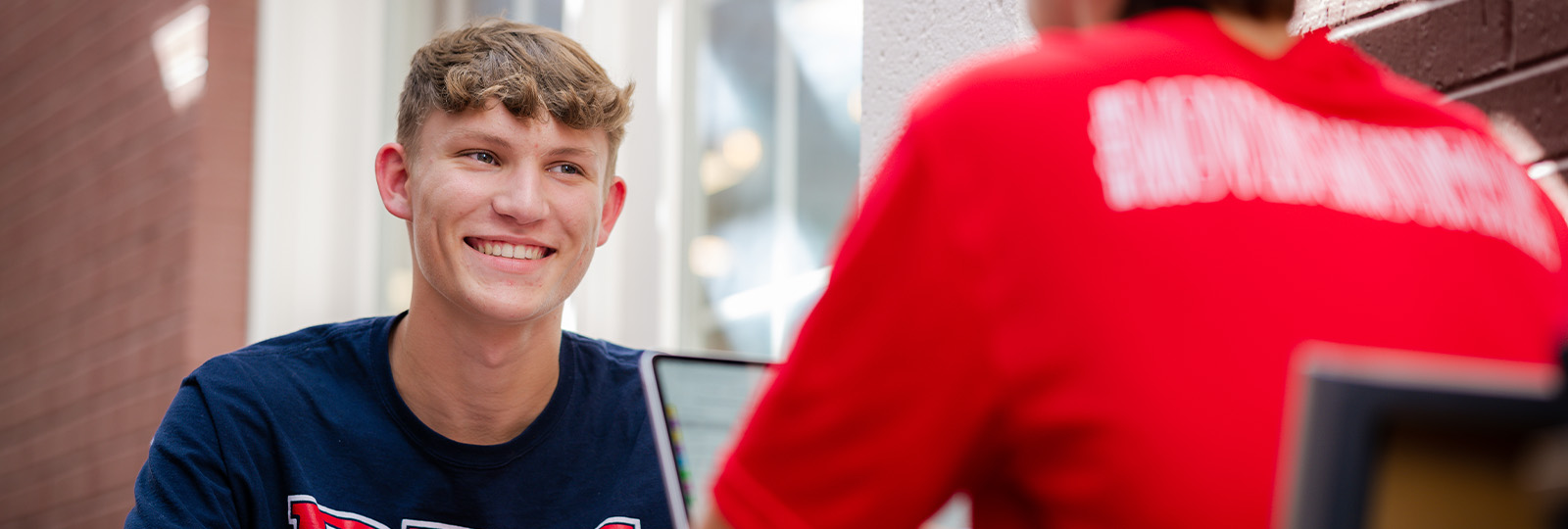 DBU students sitting on campus
