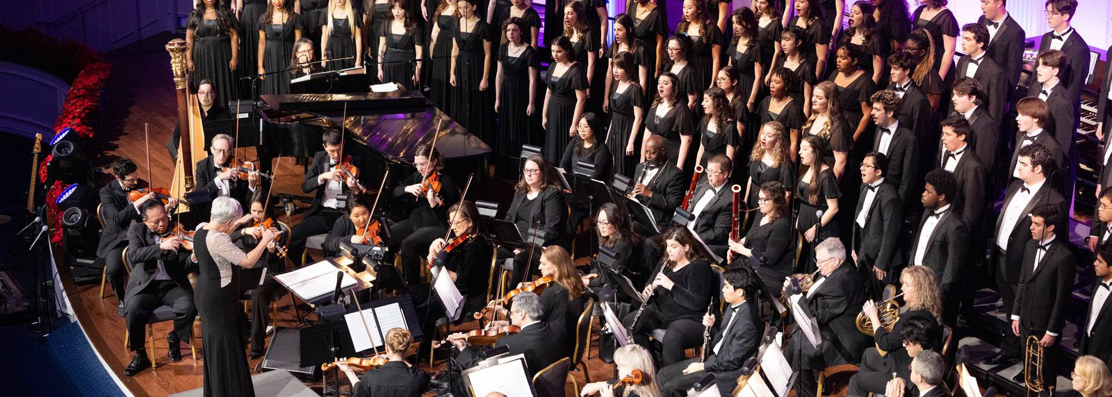 Orchestra and choir performing on stage 