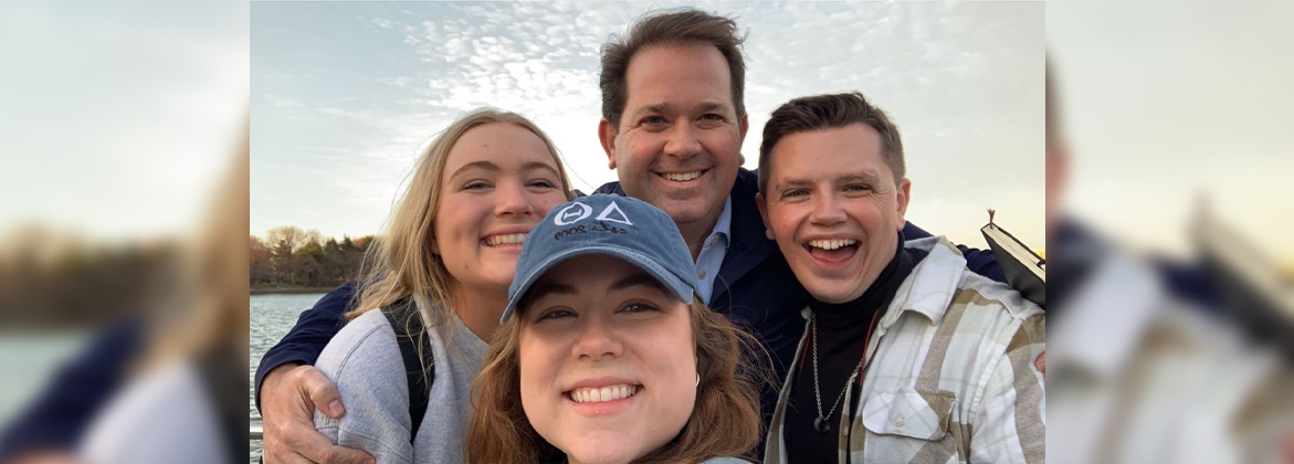 Dr. Wright poses with three students