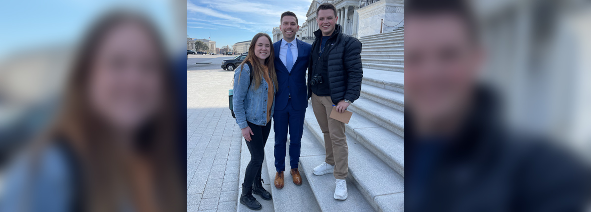 Dr. Wright poses with three students