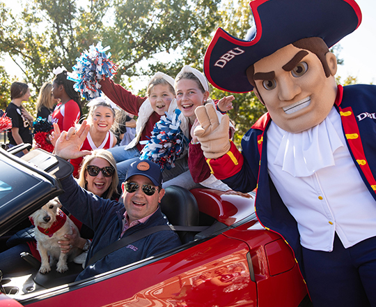Dr. Wright and his family in the Homecoming Parade along with the patriot man