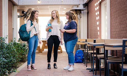 group of college girls standing outside of Spence Hall - the girls' dorm