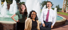  three students standing in front of water fountain