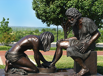 statue of a man washing Jesus' feet