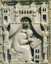 marble carving of a man writing in a book