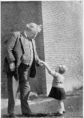 black and white picture of Chesterton shaking a little girls hand