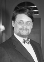 black & white headshot of Dr. Nigel M. de S. Cameron