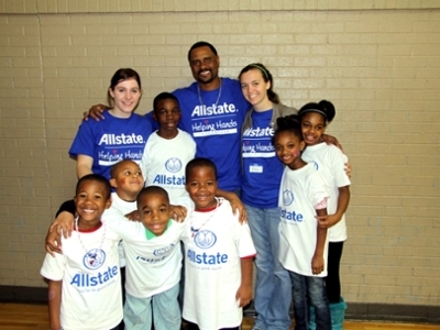 DBU swim team members Rebecca Steele (left) and Amy Brewer (right) pose with National Give Back Day Hero John Darjean (center) and several children that they worked with on Martin Luther King, Jr. Day.